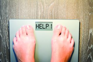 Lose weight concept with person on a scale measuring kilograms